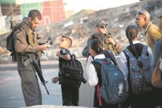 Students cross a checkpoint in the occupied west bank.